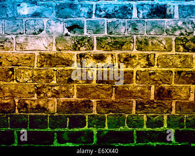 Section of stonewall coloured with blue, yellow and green overlay Stock Photo