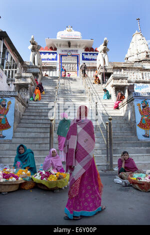Steps leading up to Jagdish Temple with women in saris selling offerings, Udaipur, Rajasthan, India Stock Photo