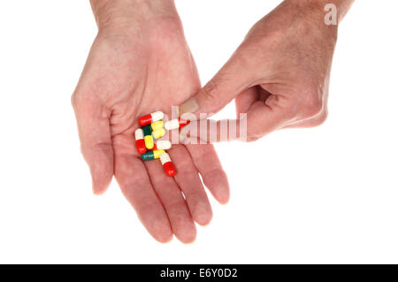 Closeup of a pair of hands holding pills isolated against white Stock Photo