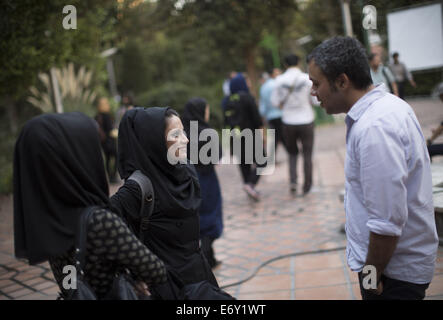 Tehran, Iran. 1st Sep, 2014. Iranian youth talk to each other as they stand in Tehran's Artists Park. Credit:  Morteza Nikoubazl/ZUMA Wire/Alamy Live News Stock Photo