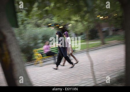 Tehran, Iran. 1st Sep, 2014. Two Iranian young women walk in Tehran's Artists Park. Credit:  Morteza Nikoubazl/ZUMA Wire/Alamy Live News Stock Photo