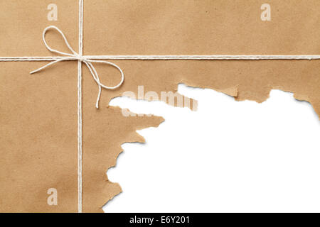 Brown Paper Package with Rope Torn Open on WHite Background. Stock Photo