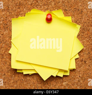 Bunch of sticky notes tacked to cork board. Stock Photo