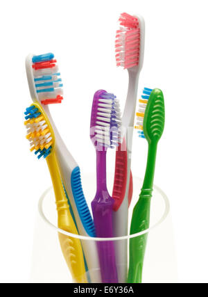 Group of Tooth Brushes in Glass Isolated on White Background. Stock Photo