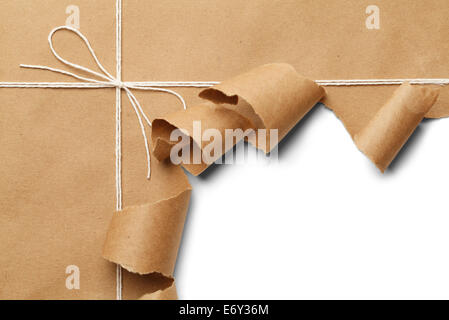 Brown Paper Parcel with Rope Torn Open on White Background. Stock Photo