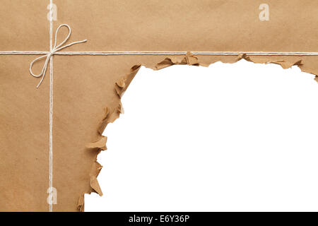 Brown Paper Package with Rope Torn Open on White Background. Stock Photo
