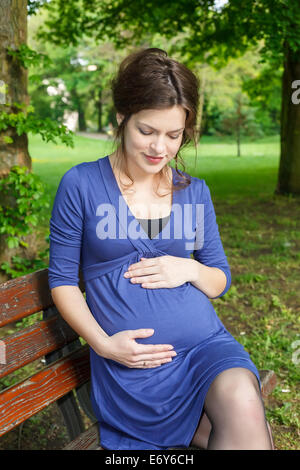 Beautiful pregnant woman in the park Stock Photo