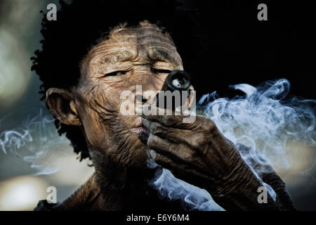 Old woman from the San tribe smoking Dagga, Otjozondjupa region, Namibia, Africa Stock Photo