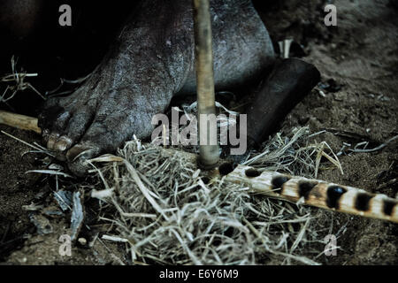 A man of the San tribe igniting a fire with two wooden sticks, Otjozondjupa region, Namibia, Africa Stock Photo