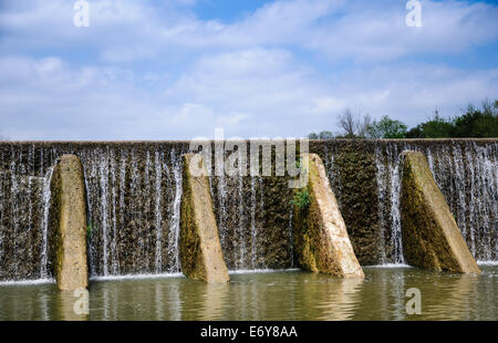 Water flowing over a stone dam in Central Texas Stock Photo