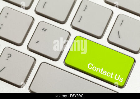 Close Up of Green Contact Us Key Button on Keyboard. Stock Photo