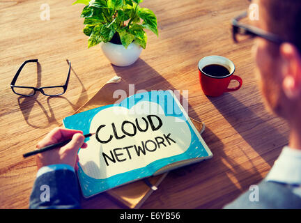 Man Writing Cloud Network Concepts on His Note Stock Photo