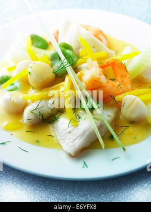 John Dory with shrimps,scallops,broad beans in citrus fruit sauce Stock Photo