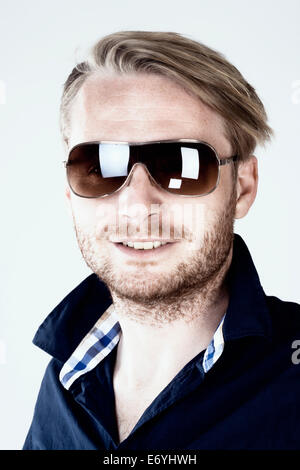 Portrait of a Young Man with Sunglasses - Isolated on Gray Stock Photo
