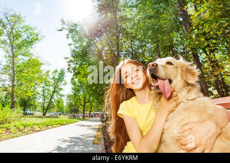 Nice girl with funny retriever dog portrait Stock Photo