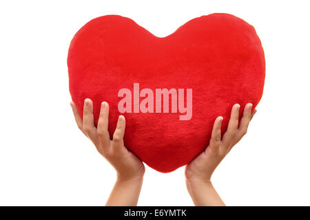 Heart in woman's hands against white background. Close-up. Stock Photo
