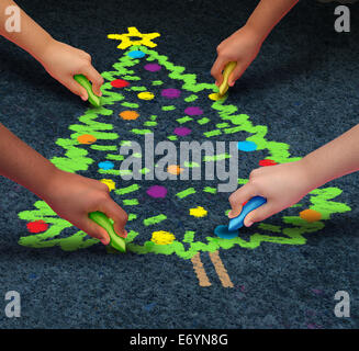 Community Christmas concept as a group of multicultural children drawiing a decorated pine tree on the floor using chalk  as a winter holiday symbol for cooperation and working together to celebrate a time of giving. Stock Photo