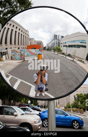 Photographer's reflection in convex mirror - USA Stock Photo
