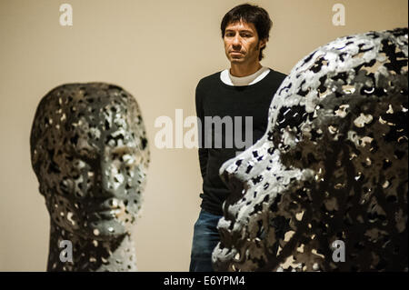 London, UK. 2nd Sept, 2014. Artist Xavier Mascaró poses next to 'Head of Eleonora' (left) and 'Head of Alexandra' (Right)  reminiscent of the profiles on ancient coins. Xavier Mascaró's first UK solo exhibition will run from 3 September until 5 October at Saatchi Gallery. Credit:  Piero Cruciatti/Ģ����ý Live News Stock Photo