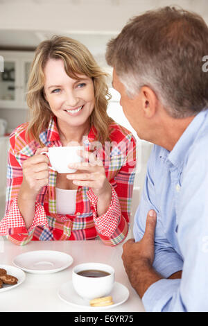 Mid age couple having coffee at home Stock Photo