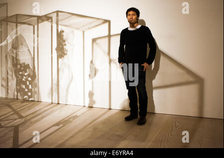 London, UK. 2nd Sept, 2014. Artist Xavier Mascaró poses next to the shadow of his works 'Masks'. Xavier Mascaró's first UK solo exhibition will run from 3 September until 5 October at Saatchi Gallery. Credit:  Piero Cruciatti/Alamy Live News Stock Photo