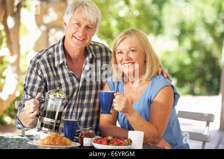 Senior couple eating breakfast outdoors Stock Photo