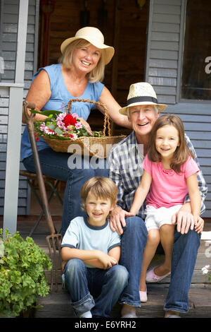 Senior couple on veranda with grandchildren Stock Photo