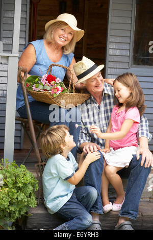 Senior couple on veranda with grandchildren Stock Photo