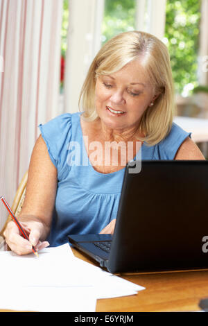Senior Woman Working In Home Office Stock Photo