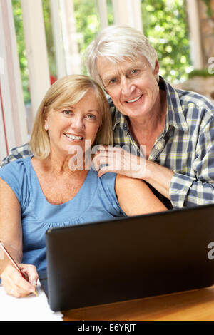 Senior Couple Working In Home Office Stock Photo