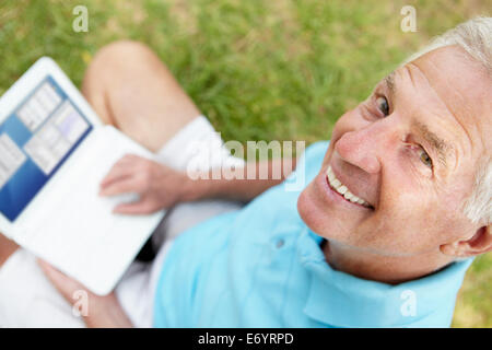 Senior man using laptop outdoors Stock Photo