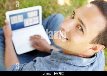 Man using laptop outdoors Stock Photo