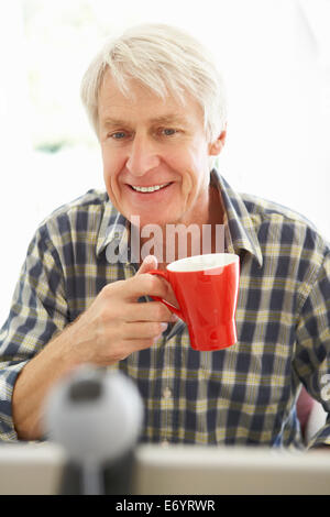 Mid age man using skype Stock Photo