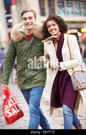 Young Couple Shopping Outdoors Together Stock Photo