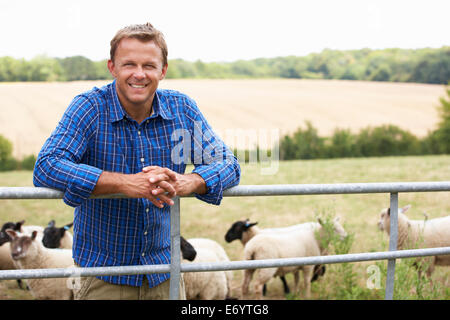 Man leaning on country fence Stock Photo