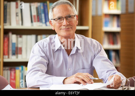 Senior student working in library Stock Photo