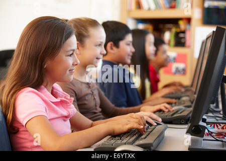 Schoolchildren working on computers Stock Photo