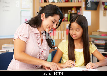Teacher and schoolgirl in class Stock Photo