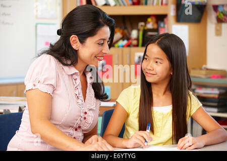 Teacher and schoolgirl in class Stock Photo