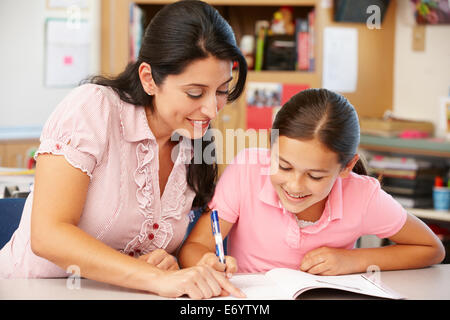 Teacher and schoolgirl in class Stock Photo