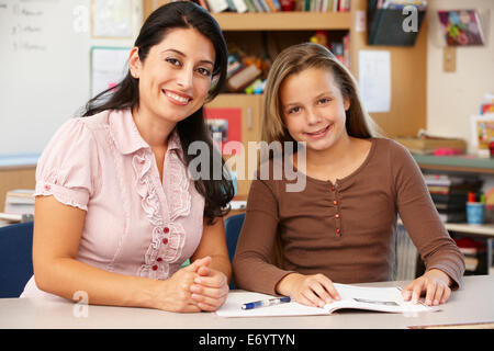 Teacher and schoolgirl in class Stock Photo