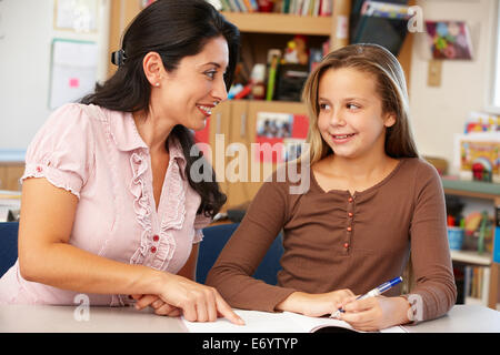 Teacher and schoolgirl in class Stock Photo