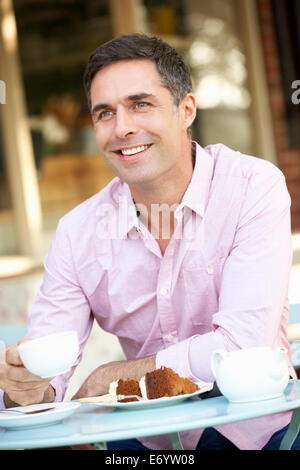 Man sitting outside cafÃ© Stock Photo