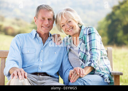 Senior couple sitting outdoors Stock Photo