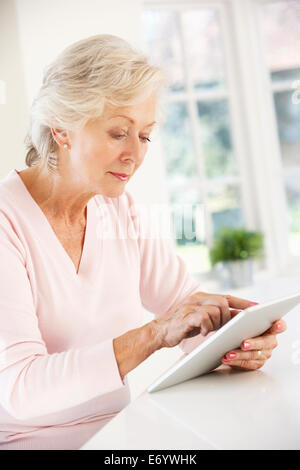 Senior woman using tablet at home Stock Photo