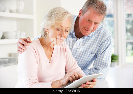Senior couple using tablet at home Stock Photo