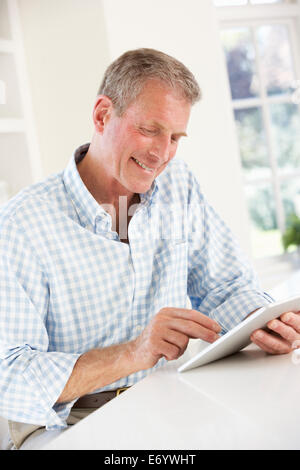 Senior man using tablet at home Stock Photo