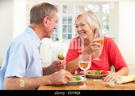 Retired couple enjoying meal at home Stock Photo