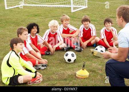 Junior football team training with coach Stock Photo