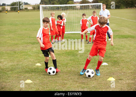 Junior football team training with coach Stock Photo
